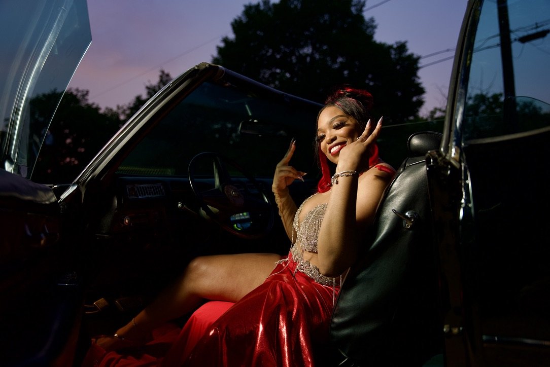 Prom portrait seated in classic convertible at dusk
