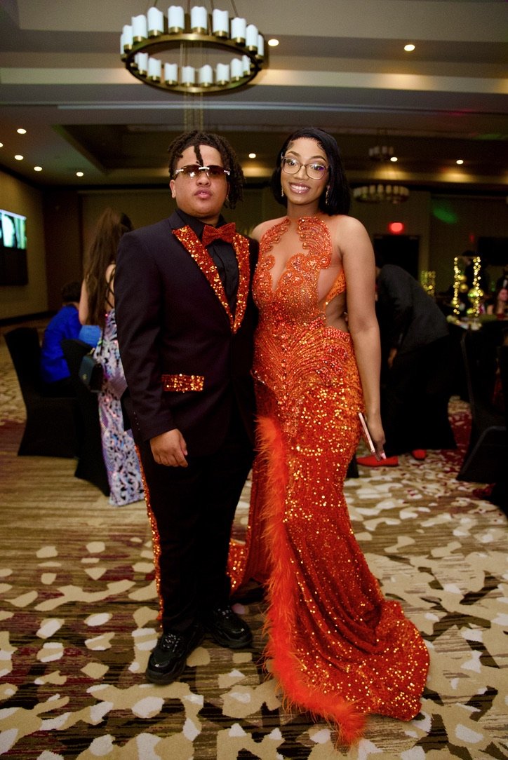 Couple in matching orange sequins